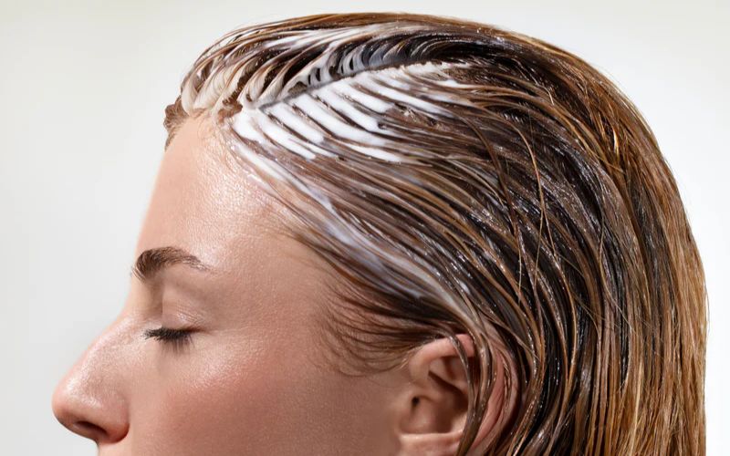 Femme qui a un masque capillaire